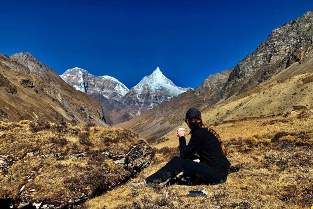 Tourist resting mountain view laya trek
